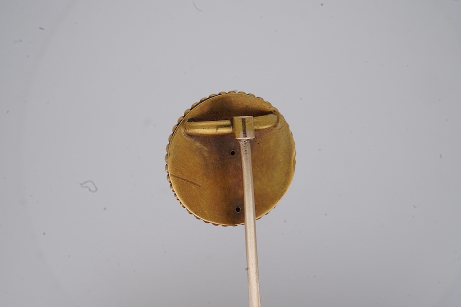 A Victorian gold and diamond stick pin, late 19th century, of circular outline with rope twist and grainti decoration, centring on a rose-cut diamond, length 7cm, gross weight 3 grams